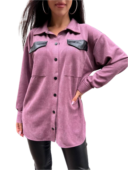 Purple shirt with black leather accents worn by a person on a white background