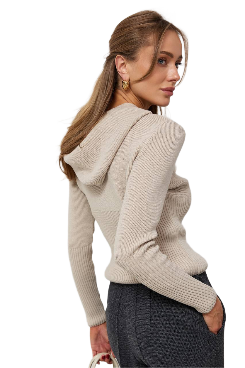 Woman wearing a beige hoodie with a plain background