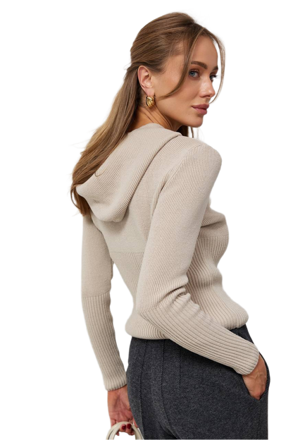 Woman wearing a beige hoodie with a plain background