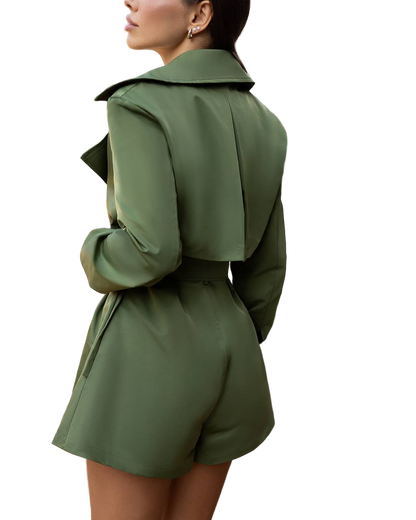 Green trench coat worn by a person on a white background