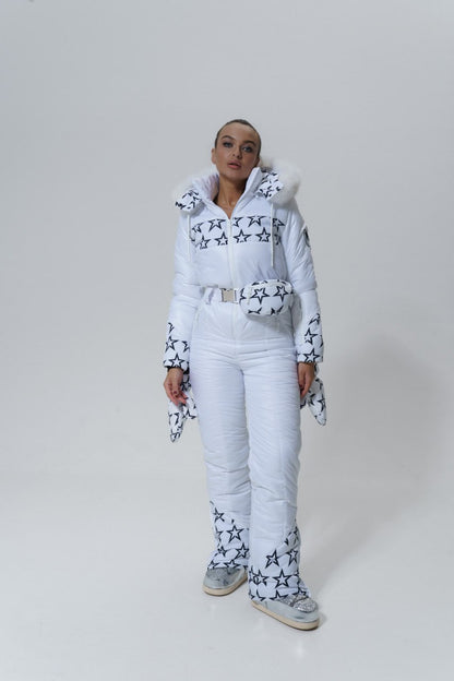 Person wearing a white outfit with star patterns on a plain background