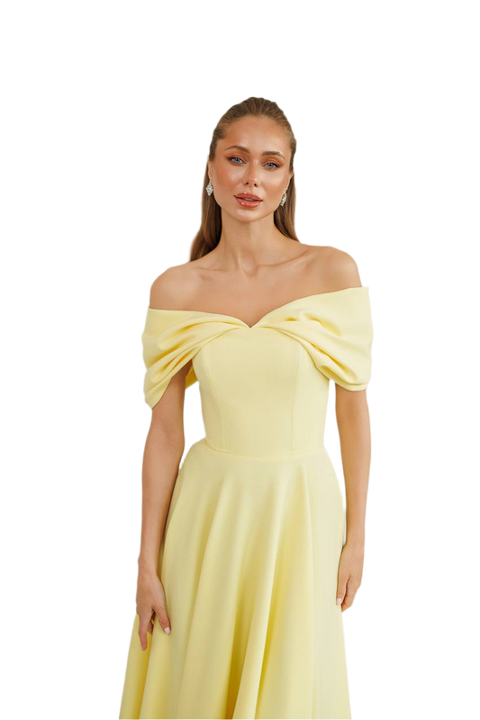 Woman wearing a yellow off-shoulder dress on a white background