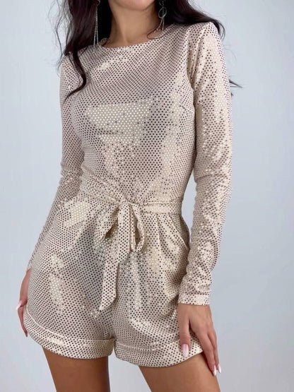 Beige patterned romper worn by a person on a plain background