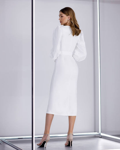Woman wearing a white outfit in a minimalistic setting
