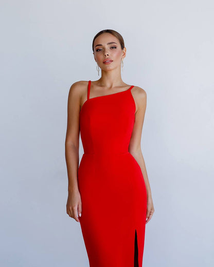Woman wearing a red one-shoulder dress against a light gray background