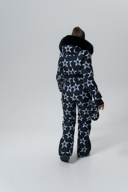 Person wearing a star-patterned snowsuit with a fur-lined hood on a white background