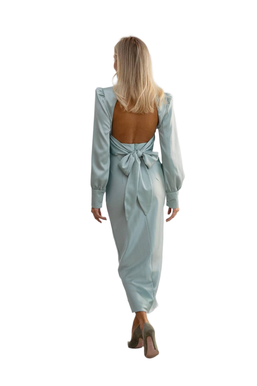 Woman wearing a light blue dress with a tie detail on a white background
