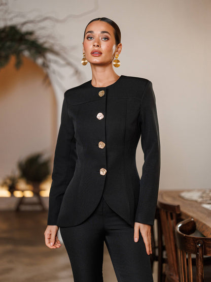 Woman wearing a black suit with gold buttons in an indoor setting