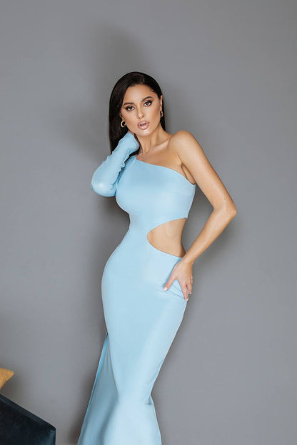 Woman in a light blue one-shoulder dress with cut-out design against a gray background