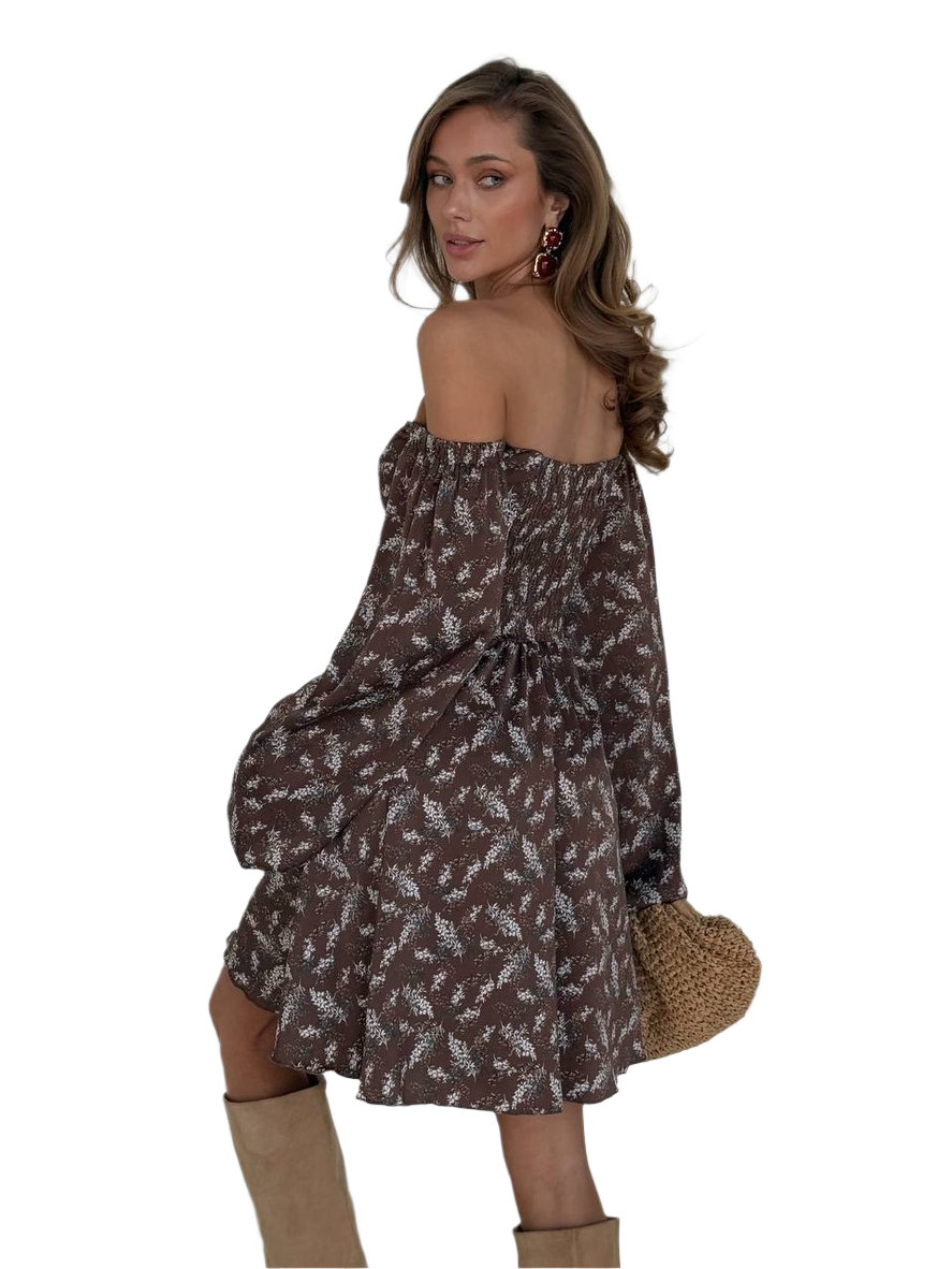 Woman wearing a floral off-shoulder dress with a white background