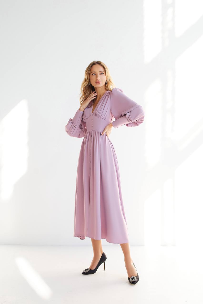 Woman wearing a pink dress against a white background