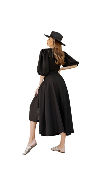 Woman wearing a black dress and hat on a white background