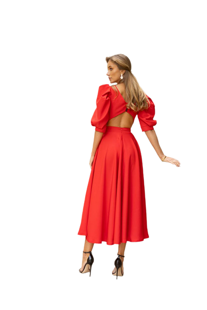 Woman wearing a red dress with puff sleeves on a white background