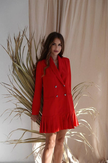 Woman wearing a red dress with a beige curtain and plant in the background