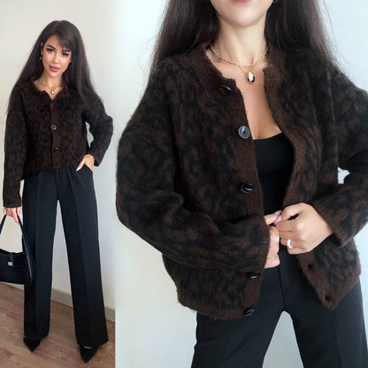 Woman wearing a brown leopard print coat with close-up details on a plain background