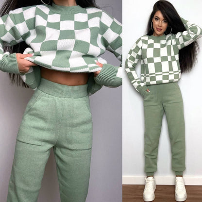 Green and white checkered sweater and pants set worn by a person against a plain background.