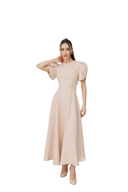 Woman wearing a beige dress with puffed sleeves on a white background