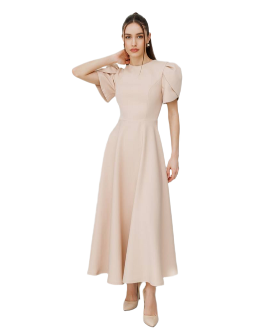 Woman wearing a beige dress with puffed sleeves on a white background