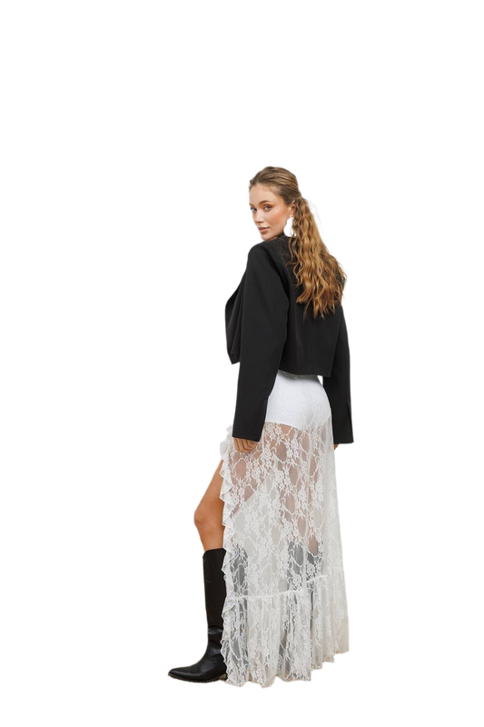 Woman wearing a black jacket, white top, and lace skirt on a white background