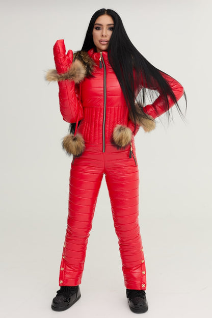 Person wearing a red puffer jumpsuit with fur-lined hood and cuffs on a white background