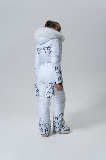 Person wearing a white puffer suit with star patterns on a plain background