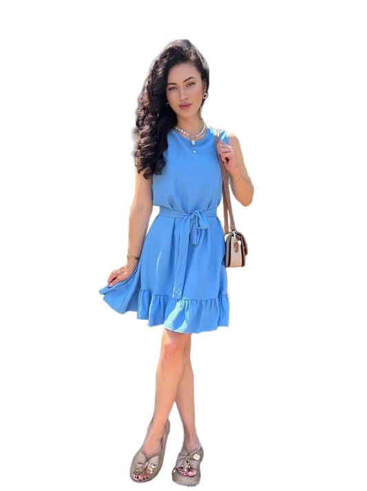 Woman wearing a blue dress holding a handbag on a white background