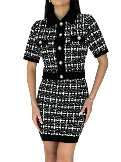 Black and white patterned dress with buttons on a white background