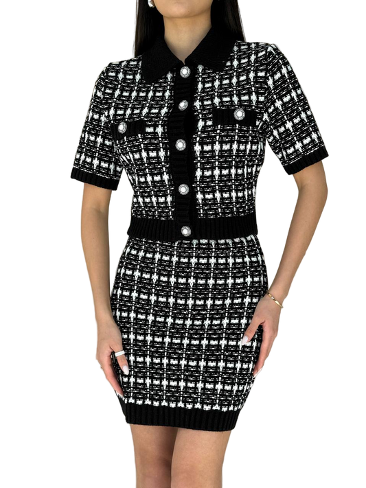 Black and white patterned dress with buttons on a white background