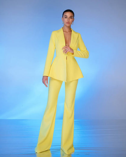 Woman wearing a bright yellow suit against a gradient blue background
