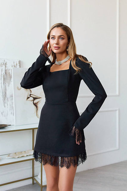 Woman wearing a black dress with lace hem in an indoor setting