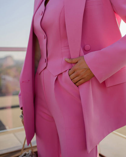 Person wearing a bright pink suit with a blurred background