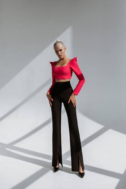 Person wearing a red top and black pants on a gray background