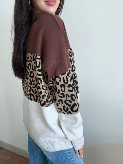 Person wearing a sweater with brown and beige leopard print pattern
