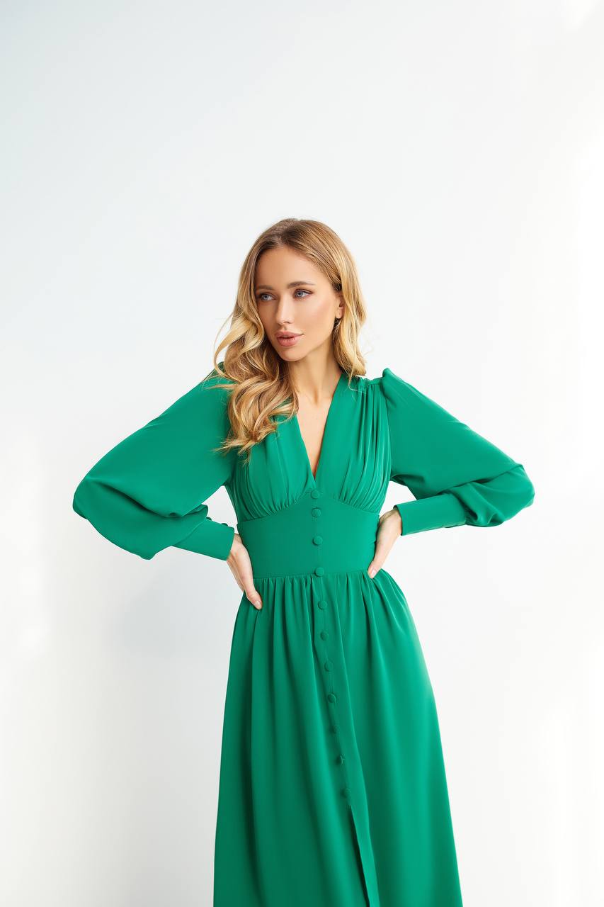 Woman wearing a green dress against a white background