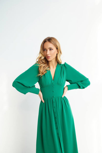 Woman wearing a green dress against a white background