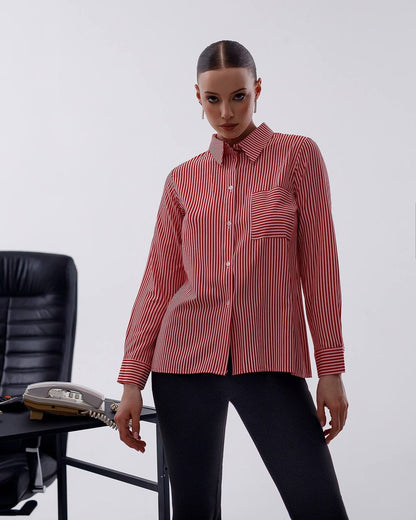 Person wearing a red and white striped shirt with a blurred office chair in the background