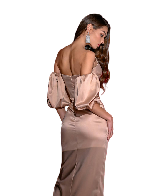 Woman wearing a beige off-shoulder dress with sheer panels on a white background