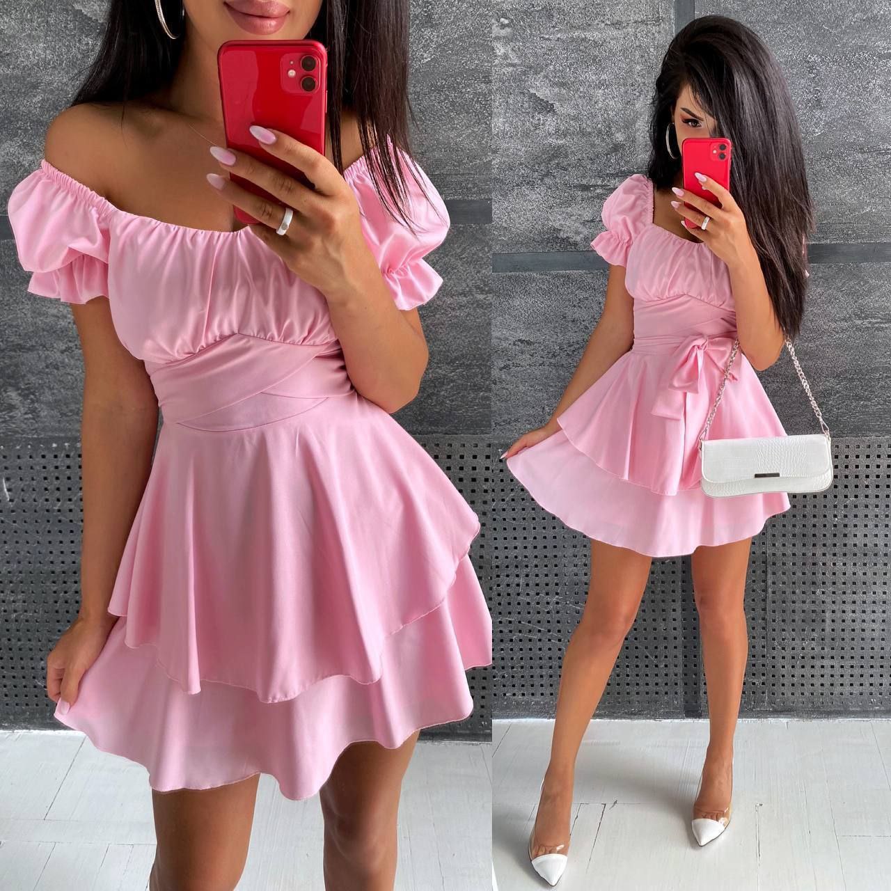 Woman wearing a pink off-shoulder dress against a gray wall.