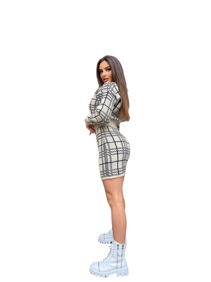 Woman wearing a black and white checkered outfit with white boots on a white background
