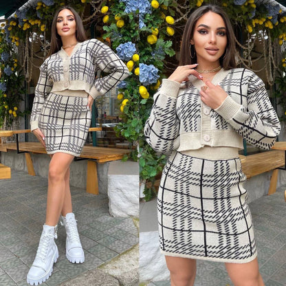 Woman wearing a checkered outfit with a white cardigan and skirt, standing outdoors.