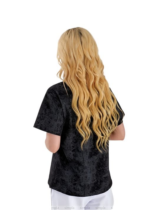 Person wearing a black textured shirt with long blonde hair on a white background