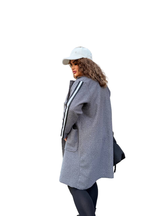 Person wearing a gray coat with a white cap on a white background