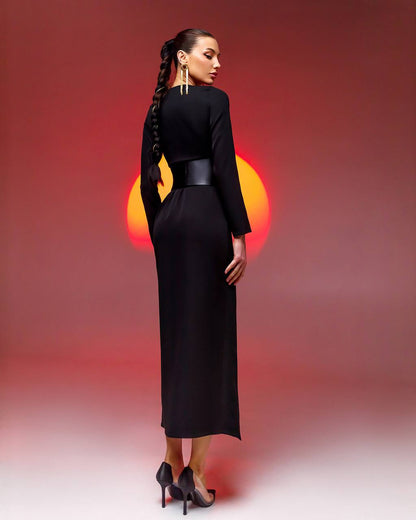Woman in a black dress with a red and orange light in the background