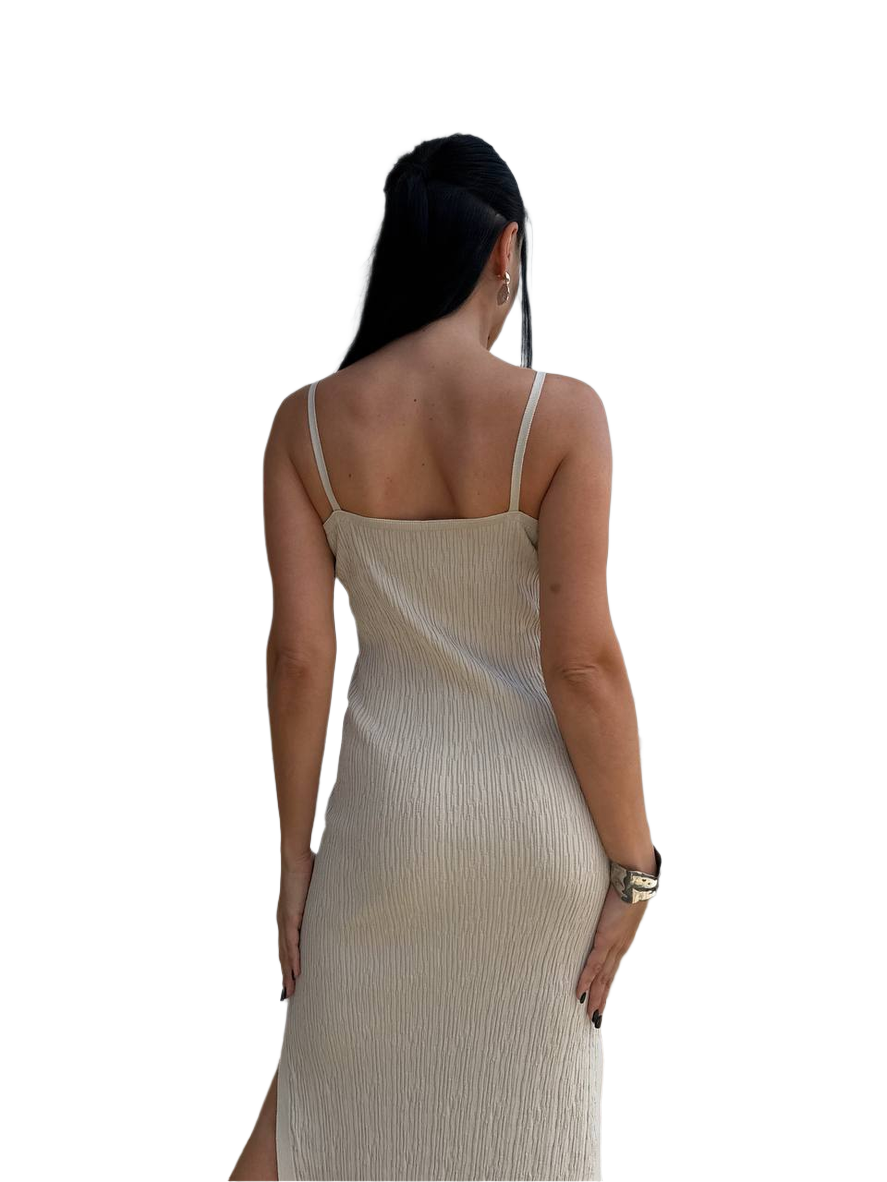 Woman wearing a beige slip dress on a white background