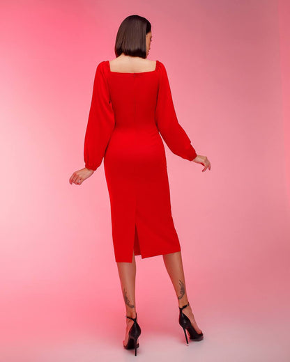 Woman wearing a red dress against a pink background