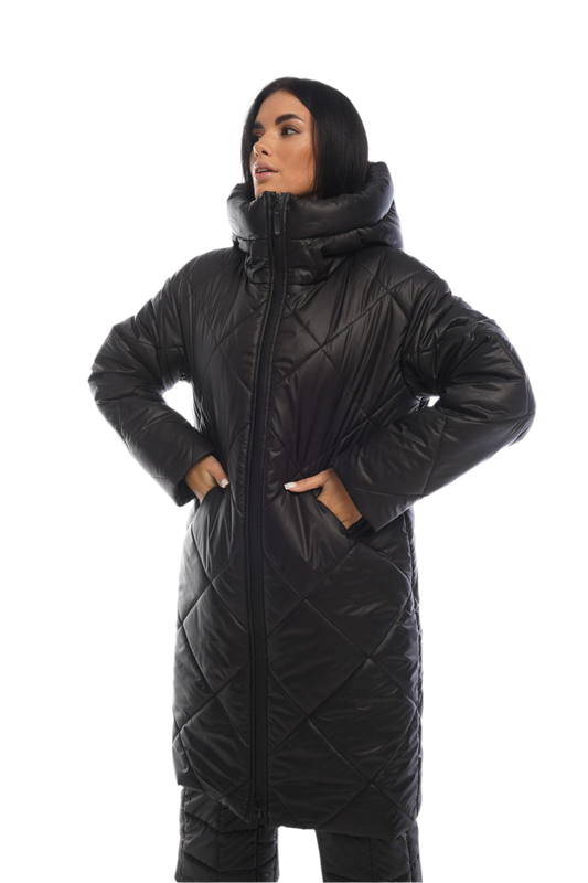 Person wearing a long black quilted coat on a white background