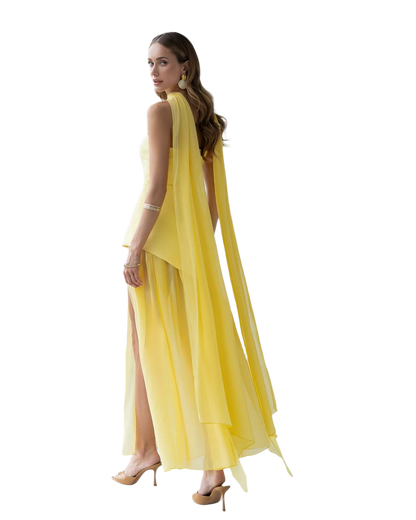 Woman wearing a yellow dress with a slit on a white background