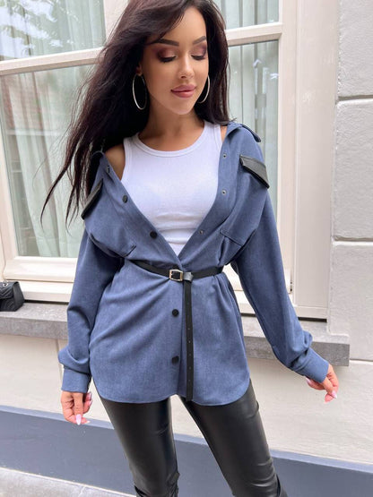 Woman wearing a blue jacket with a white shirt and black pants outdoors.