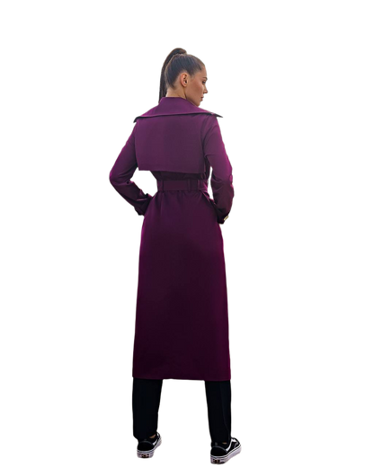 Person wearing a long purple coat on a white background