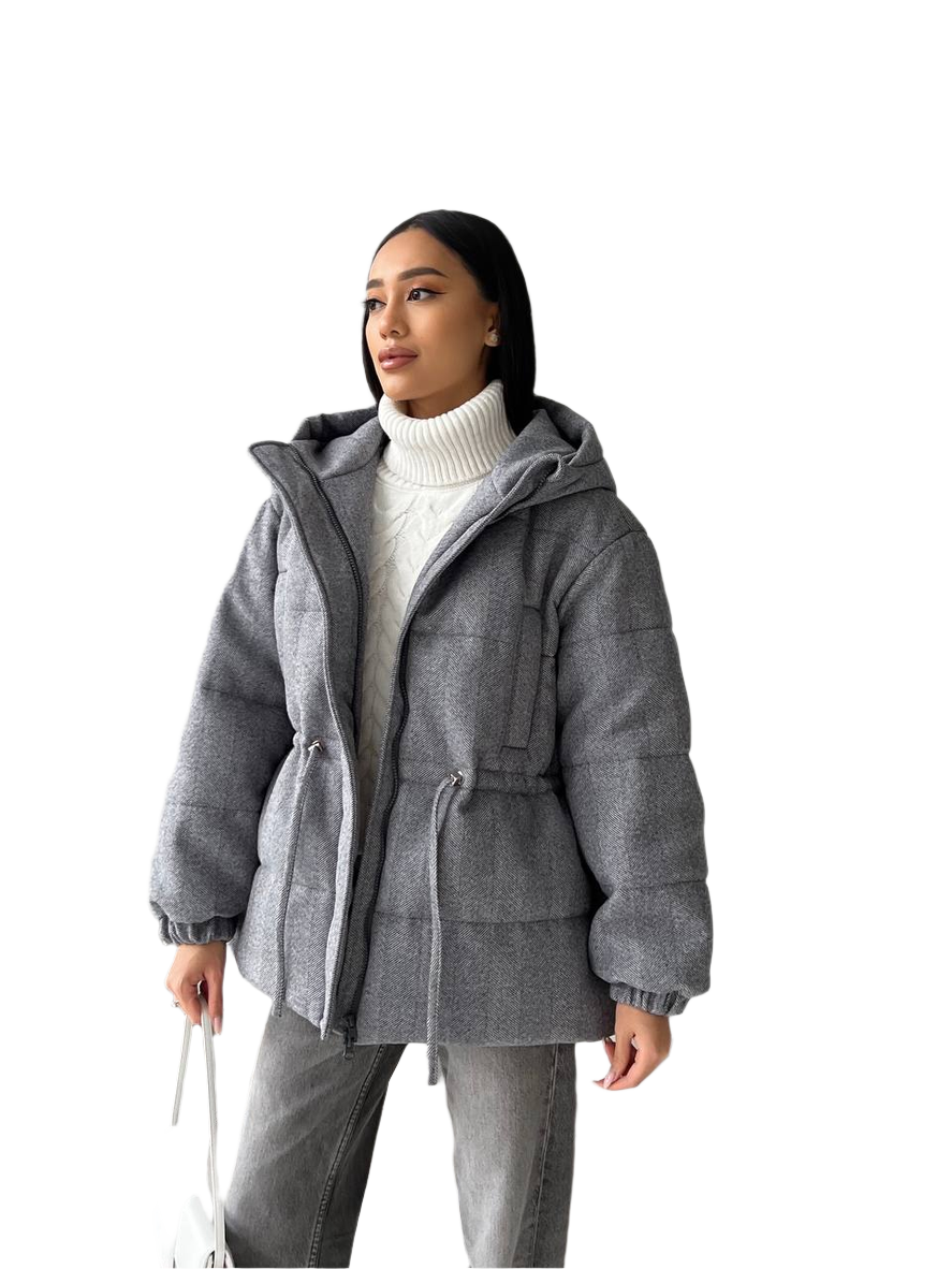 Woman wearing a gray hooded jacket on a white background